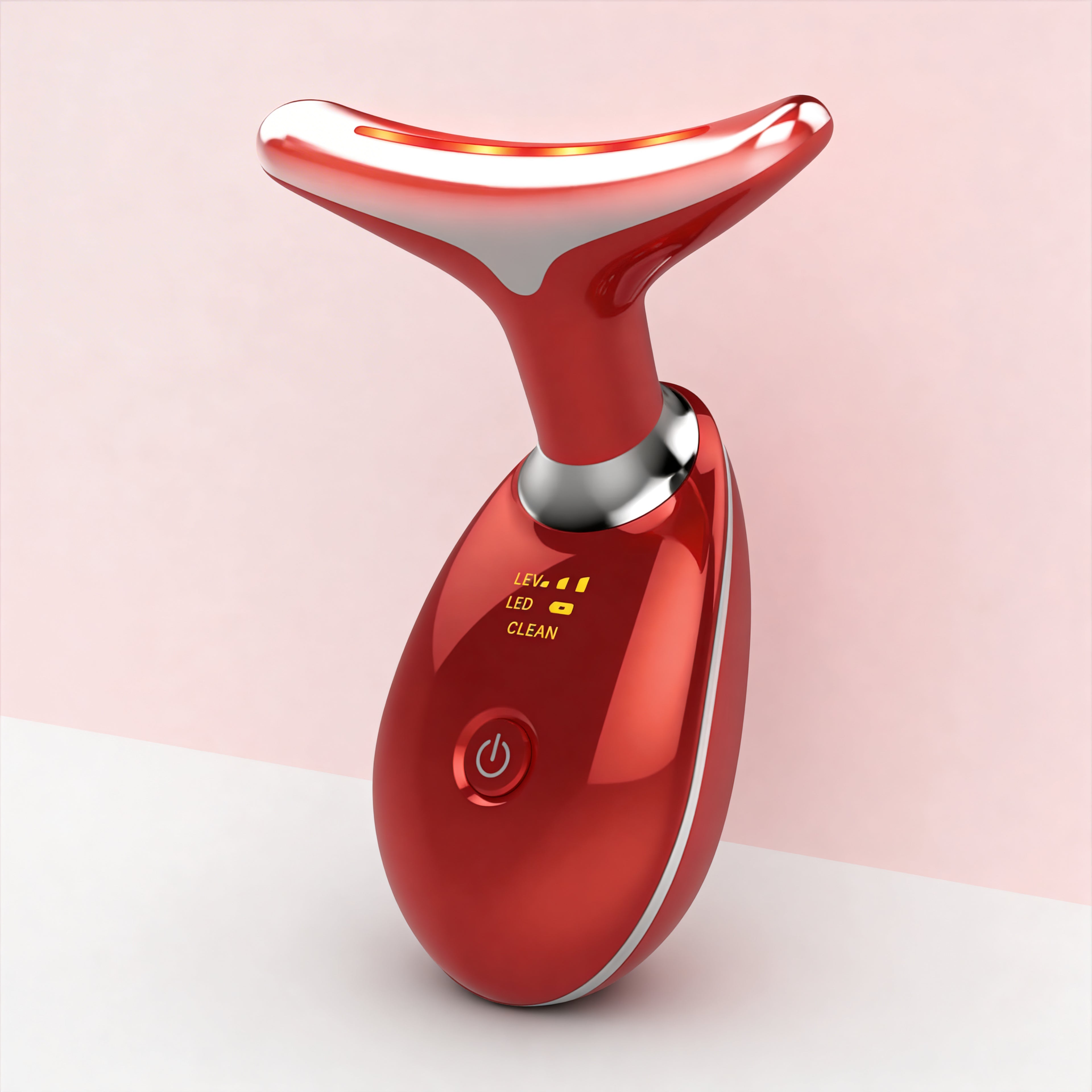 Red electronic device with a power button on a light pink background