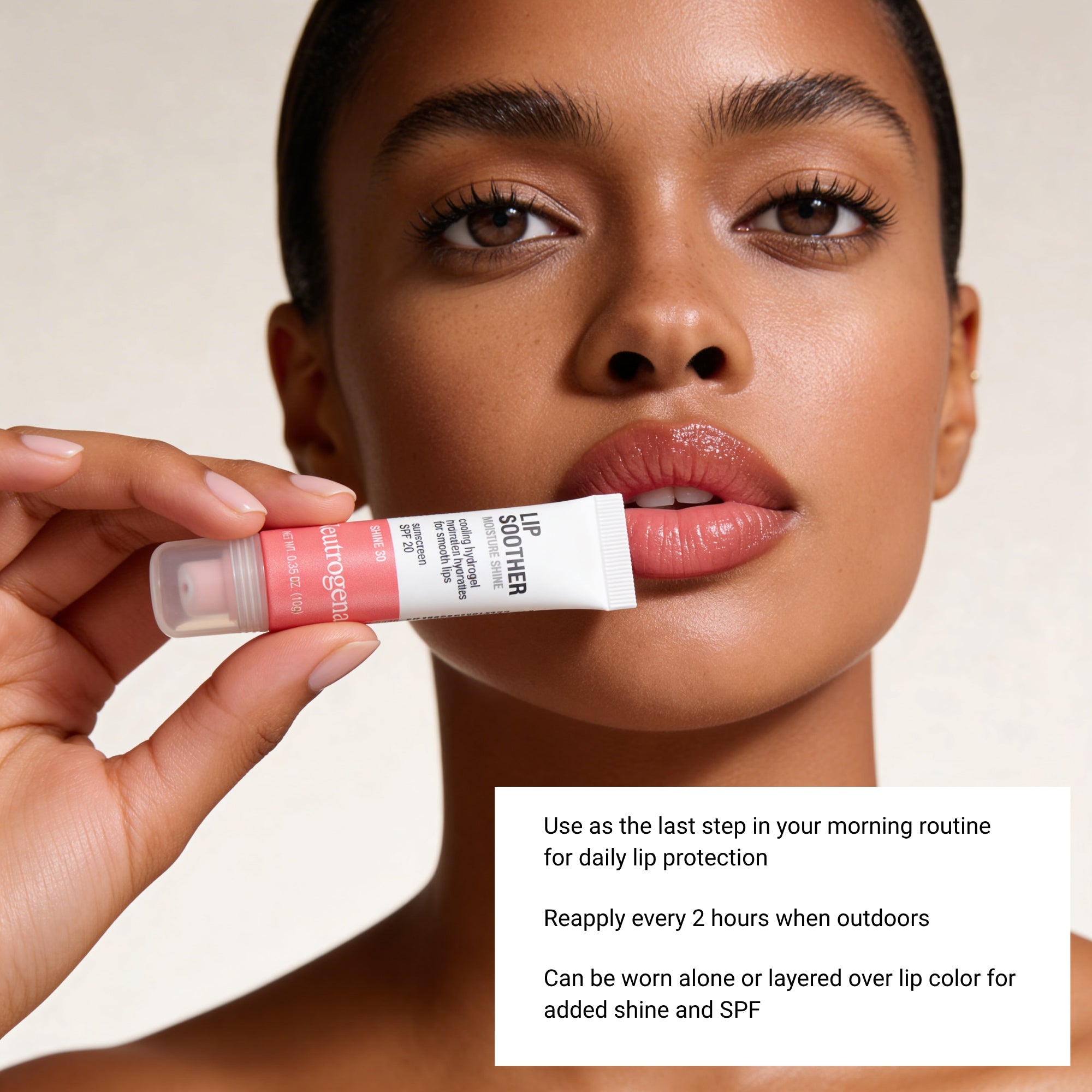Woman holding a lip balm with product details on a beige background