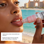 Person applying lip balm with a scenic background