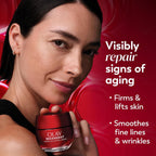 Woman holding an Olay Regenerist skincare product with promotional text on a red background