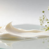 Cream on a glass surface with small white flowers