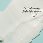 Close-up of a fluffy light texture with text on a light blue background