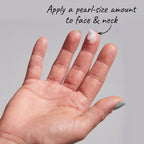 Hand with pearl-sized amount of cream on指尖, against a gray background