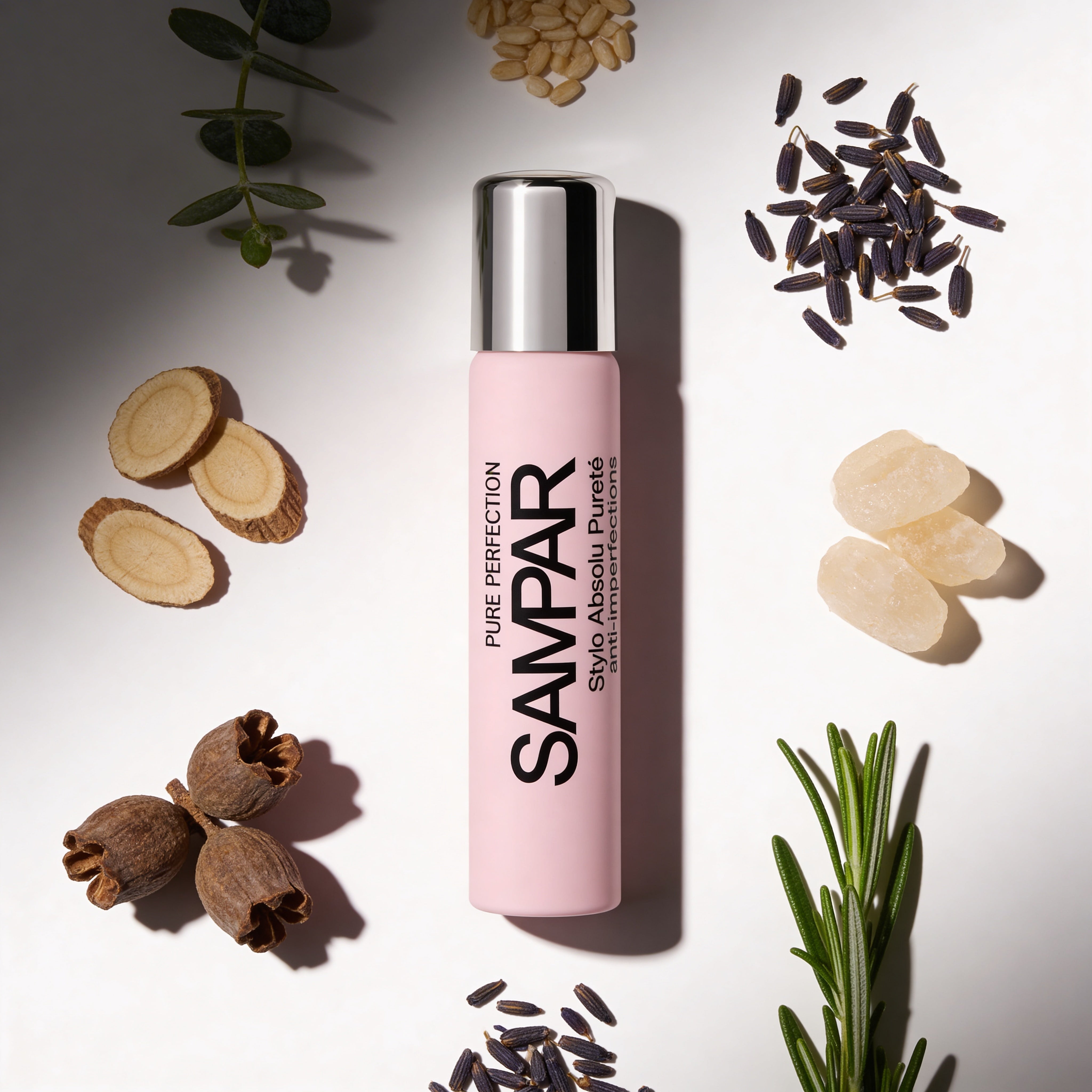 Pink SAMPAR perfume bottle surrounded by dried plants and seeds on a light background