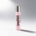 Pink bottle with silver cap on a gray background