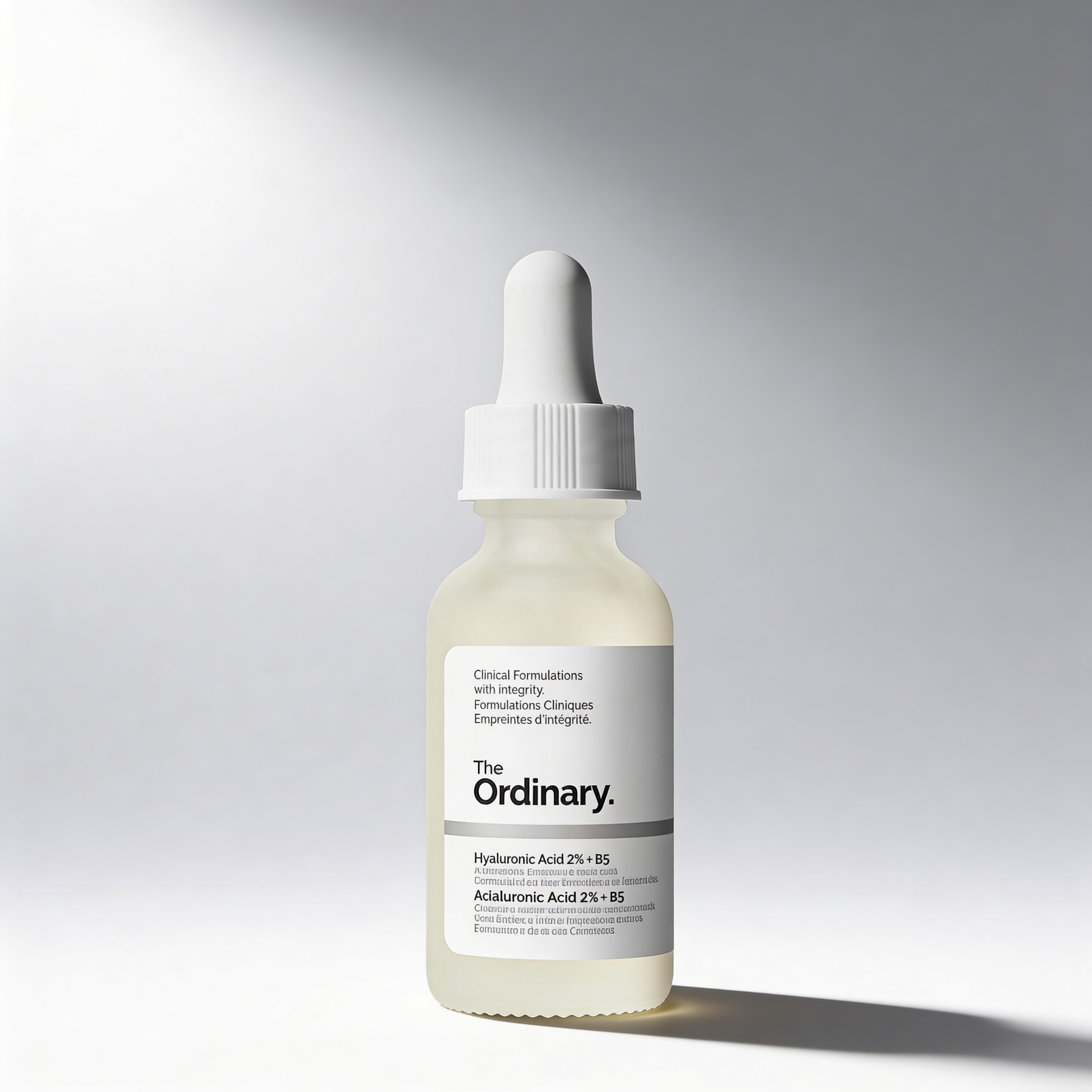 Skincare dropper bottle with 'The Ordinary' label on a gray background